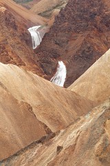 Waterfall through red Rhyolite in Iceland