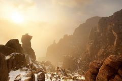 stac pollaidh in the cloud lit by golden light