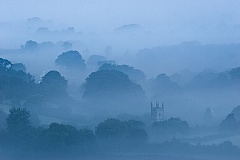 blue mist surrounds mary tavy church in Devon
