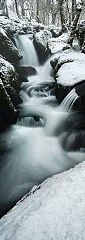 a waterfall in the winter surrounded by snow in Deovn