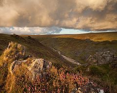 dark clouds form over tavy cleave at sunset