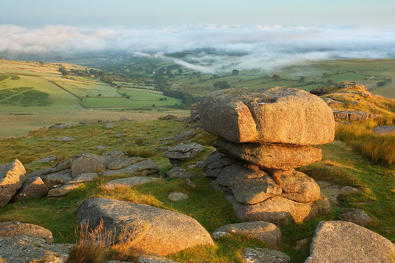 Roos Tor on Dartmoor at sunrise with mist below