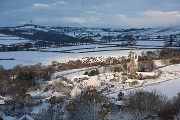 sunlight hits the devon village of Peter Tavy in the snow