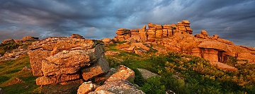 a dramatic sky over Pew Tor lit by the setting sun