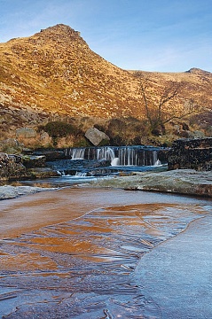 sunrise at tavy cleave with a frozen pool in the foreground