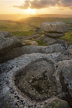 The sun sets behind Roos Tor witha  view over west Devon